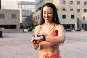 Portrait of brazilian female with wearable technology. Middle age woman checking activity